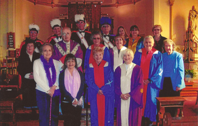 Members of the St. Francis chapters of the Knights of Columbua and of the Catholic Daughters gather in the church.