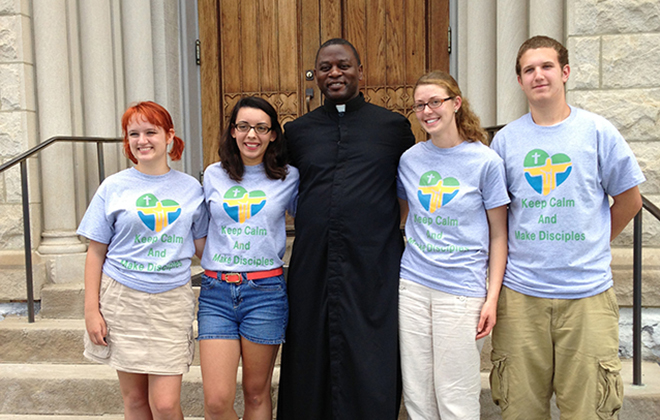 The pastor gathers with young people from the parish preparing to depart for World Youth Day in Rio in 2013.