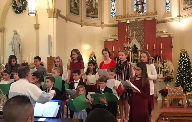 The Youth Christmas Choir under the direction of Don Roe presented Christmas carols before the 5 p.m. Mass on Christmas Eve, 2018.