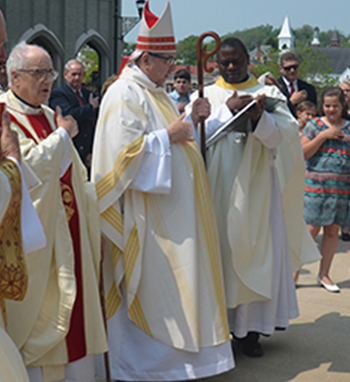 Bishop DiLorenzo dedicates the renovated St. Francis Church. Fr. Joseph Wamala, former pastor, is at right.