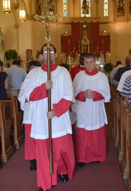 Altar servers lead the procession down the aisle at the conclusion of Mass.
