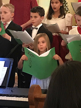 At Christmas the Children’s Choir sings carols before the 5 p.m. Mass.